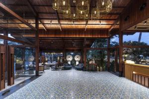 a rendering of the lobby of a resort with chandeliers at Radhe Upavan Resort in Ahmedabad
