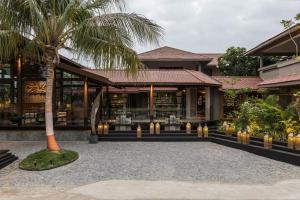 a restaurant with a palm tree in front of it at Radhe Upavan Resort in Ahmedabad