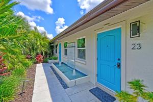 a home with a blue door and a swimming pool at Siesta Key Palms Resort in Sarasota