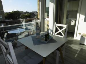 a white table and chairs on a balcony with a view at Haus Rainer SM in Büsum