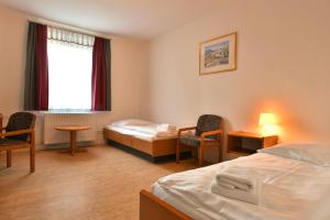 a hotel room with two beds and a window at SKYAPPART Merseburg in Merseburg