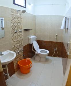 a bathroom with a toilet and a sink at Siva Residency in Mahabalipuram