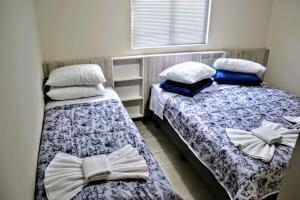 Un pat sau paturi într-o cameră la Ideal Lages Hotel