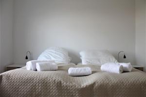 a white bed with towels on top of it at Hotel Nuka in Ilulissat