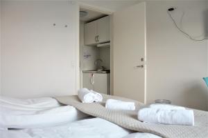 a room with a bed with towels on it at Hotel Nuka in Ilulissat