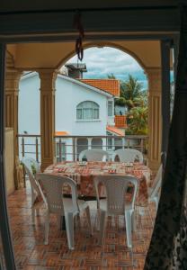 a table and chairs on a patio with a view of a house at RS VILLAS private apartment with pool and free wifi in Flic-en-Flac