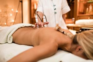 a woman in a spa salon getting her backlished at Hotel Genziana in Selva di Val Gardena