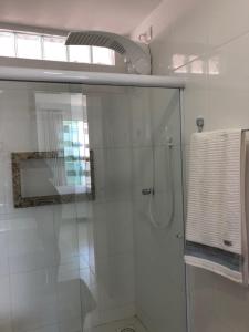 a bathroom with a shower with a glass door at Apartamento Luxuoso com Vista in Ilhéus