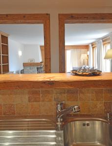 a kitchen with a sink and a mirror at Grands Ducs 328 in Bagnes