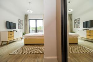 a bedroom with a bed and a mirror at Sarah Deluxe Apartment in SILVER MOUNTAIN in Poiana Brasov