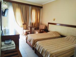 Postel nebo postele na pokoji v ubytování Filoxenia Hotel