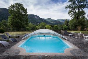 a swimming pool with a cover on top of it at Le Kino Panorama in Vic-sur-Cère