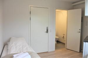 a bedroom with a door leading to a bathroom at Hotel Nuka in Ilulissat