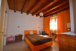 a bedroom with an orange bed in a room at Attico in centro storico con wifi e posto auto privato - CIR VDA AOSTA 0267 in Aosta