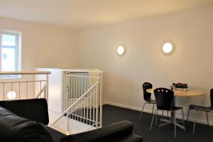 a living room with a couch and a table and chairs at Hotel Nuka in Ilulissat