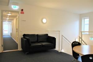 a black leather chair in a room with a table at Hotel Nuka in Ilulissat