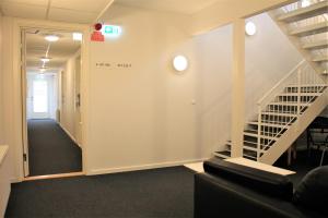 a hallway with a staircase in a office building at Hotel Nuka in Ilulissat
