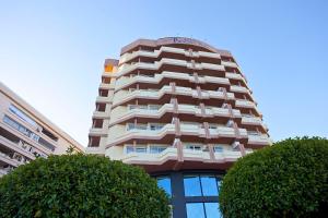 a tall building with trees in front of it at Ona Princesa Playa in Marbella