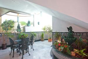 a balcony with a table and chairs and plants at Ona Princesa Playa in Marbella