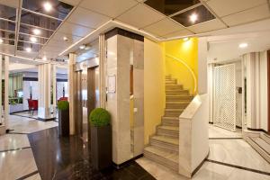 a lobby with a staircase in a building at Ona Princesa Playa in Marbella