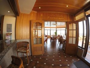 a restaurant with wooden walls and tables and chairs at Hotel Apartamentos Princesa Playa in Marbella