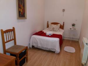 A bed or beds in a room at Casa de Huéspedes Prada