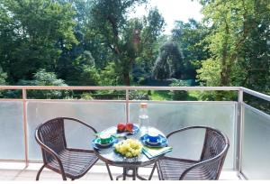 a table with a bowl of fruit on a balcony at BOTANIKA in Bologna