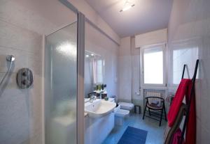 a bathroom with a shower and a sink and a toilet at BOTANIKA in Bologna +21 photos