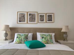 a bed with a green pillow on top of it at Apartment Štefánka in Púchov