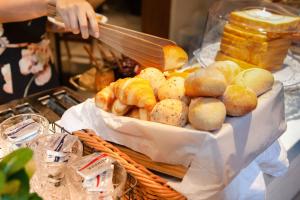 a person is making bread and pastries on a table at Volve Hotel Bangkok in Bangkok
