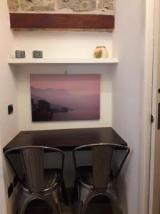 a black table and two chairs in a room at Civico29 Rooms & Breakfast in Como