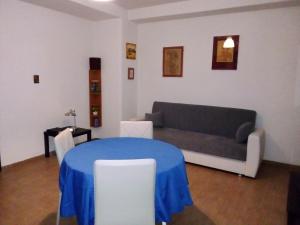 a living room with a blue table and a couch at B&Bari in Bari