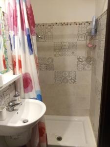 a bathroom with a sink and a shower at B&Bari in Bari