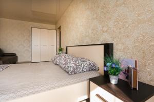 a bedroom with a bed with a pillow on it at Luxury apart-hotel on Kharkovskaya neer Manufaktura in Sumy