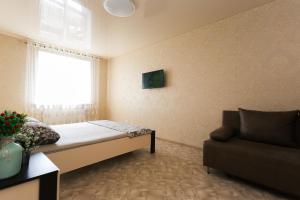 a small room with a bed and a couch at Luxury apart-hotel on Kharkovskaya neer Manufaktura in Sumy