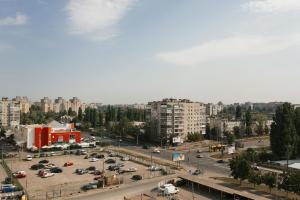 a city with cars parked in a parking lot at Luxury apart-hotel on Kharkovskaya neer Manufaktura in Sumy