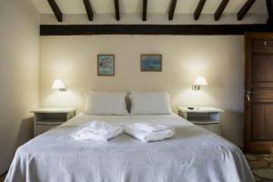 a bedroom with a bed with two towels on it at Pousada Blue Ocean in Búzios