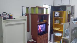 a living room with a tv in a room at Flat Botafogo in Rio de Janeiro