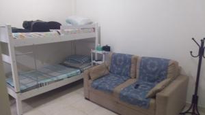 a living room with a couch and a bunk bed at Flat Botafogo in Rio de Janeiro