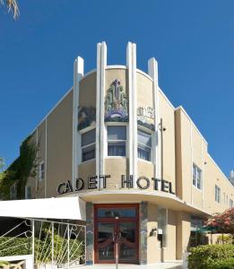 a large building with a clock on the front of it at Cadet Hotel in Miami Beach