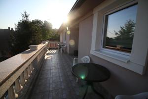 a balcony with a table and a window at Hostel Teresianum in Aleksinac