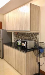 a kitchen with a counter with a microwave on it at Arcadio's Guest House in Mactan, Cebu in Cebu City