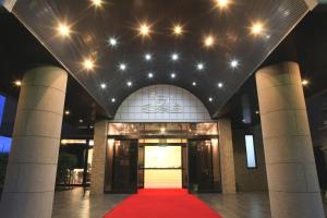 a red carpet in front of a building with lights at Royal Hotel Uohachi in Toyota