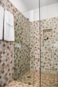 a bathroom with a shower with a glass door at TecnoHotel Valladolid in Valladolid