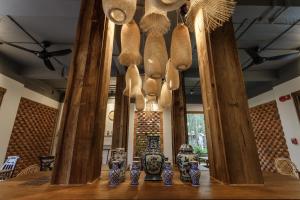 a group of vases on a table with wooden beams at The Locals Chiang Mai in Chiang Mai