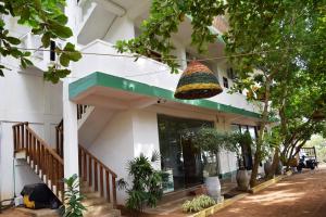 a building with a basket hanging in front of it at Rupa's Hotel in Arugam Bay