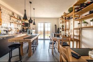 a kitchen with wooden tables and stools in it at Magnolia by Radovanovic in Ždrelo