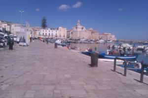 a pier with boats in the water next to a city at B&Bari in Bari