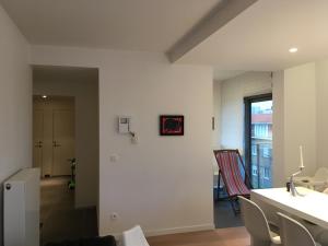 una sala de estar con mesa y sillas y una habitación en Bel appartement Zeebruges, en Zeebrugge