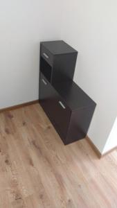 a black dresser in a corner of a room at Самостоятелен етаж от къща за гости in Haskovo